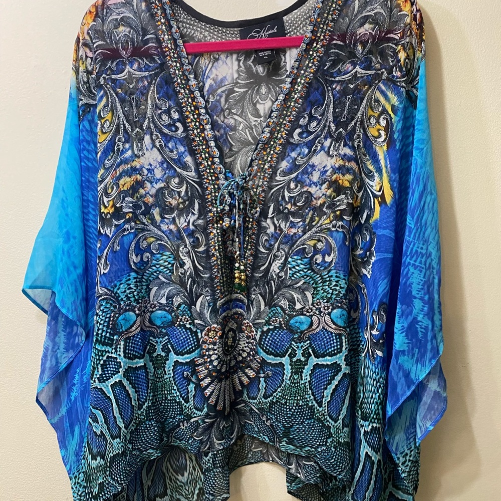 Elegant, detailed flowy top with stone designs in neckline